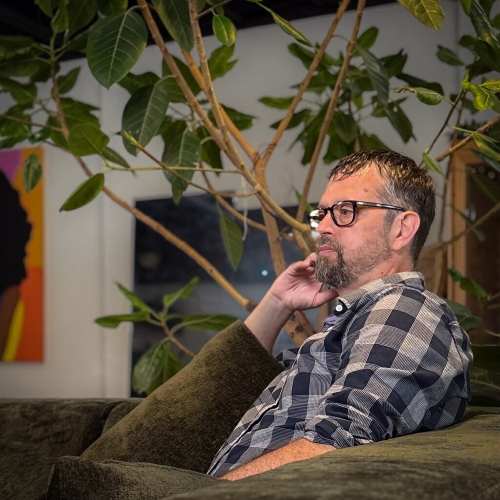 Mike Dolinsek, personal development coach, seated in a relaxed conversation